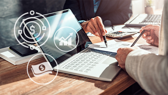 coworkers pointing at marketing reports on laptop and marketing finance icons