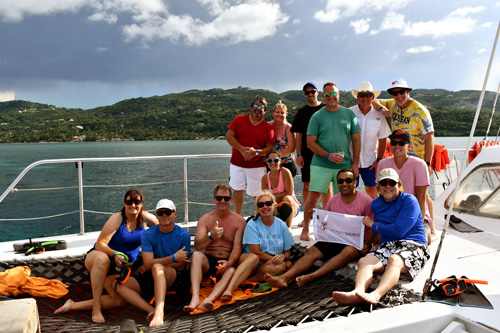 CapabilitySource team smiling on a boat during team vacation trip