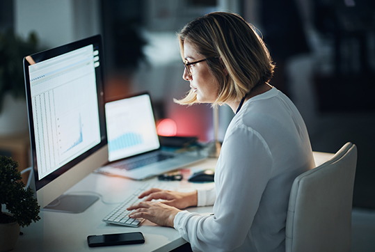 Businesswoman creating a digital graph for the latest set of data on her laptop.